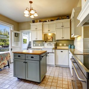 Small kitchen interior with white wooden cabinets
