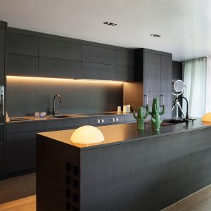 kitchen with black furniture and wooden floor

