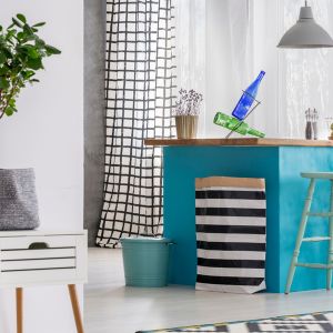 Blue kitchen island in a white dining room interior