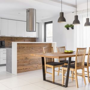 White kitchen with island, table and chairs
