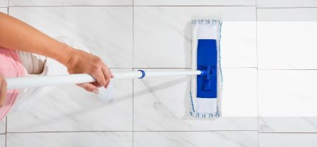 Woman cleaning the bathroom tiles