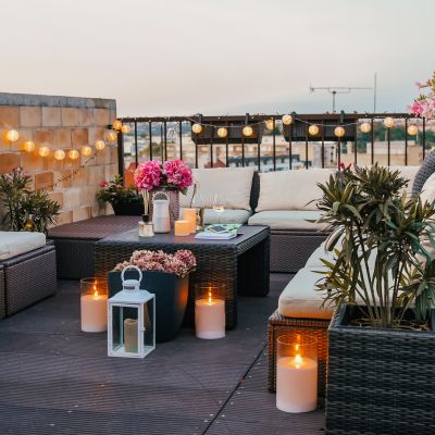 terrace deocartion with with flowers, candles, and lights