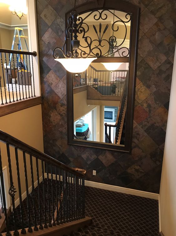 Decorate a lovely staircase landing with the help of brick wall painting designs