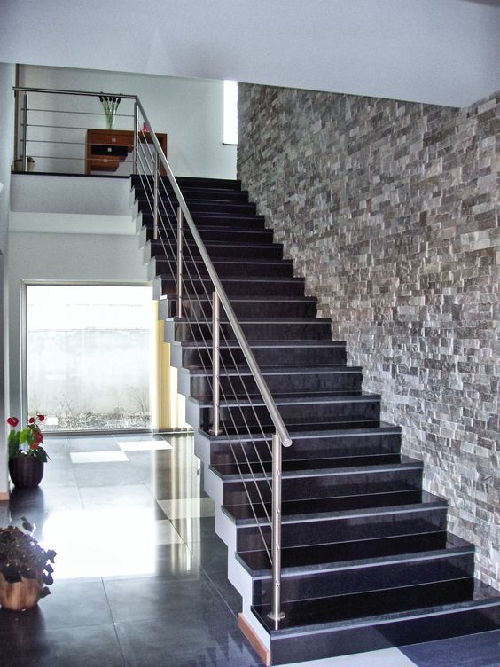 Elevate your staircase area with an entire brick wall