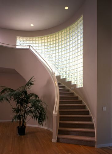 Usher in an airy staircase area with glass 