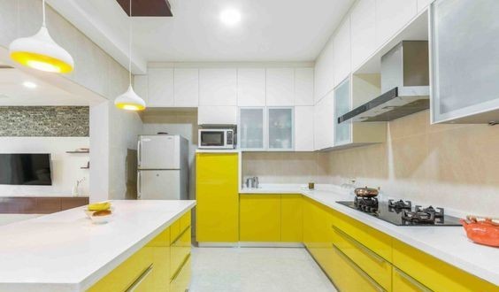 A bright yellow and white u-shaped kitchen design is perfect for large kitchens in villas and bungalows.