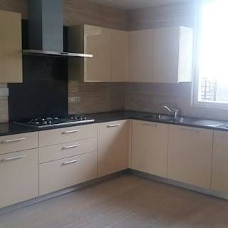 A u-shaped kitchen near the window is perfect to incorporate the kitchen sink in the design as well.