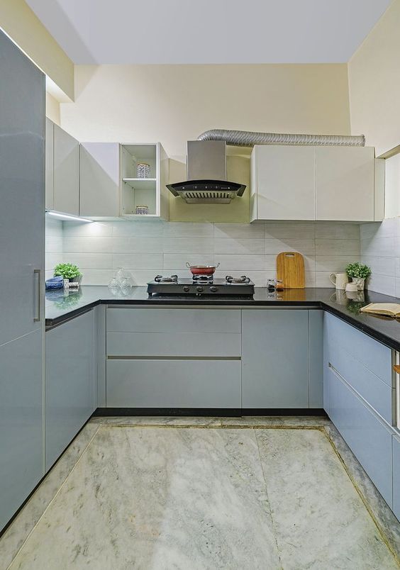 Using negative space to create enough room for chimney installation makes this u-shaped kitchen design unique and special.