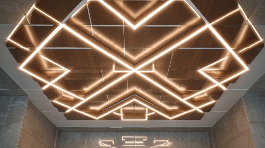 Modern ceiling featuring minimalist cross-shaped LED tube lighting