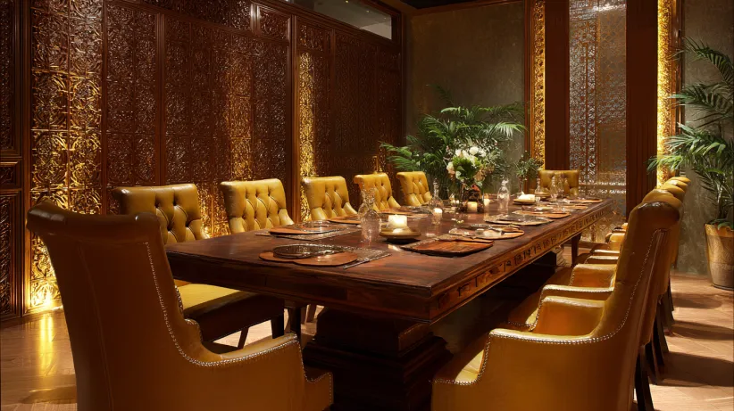 Large wooden table with tufted gold leather chairs in a grand room