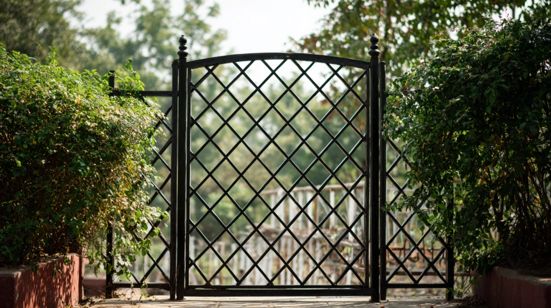 Curved metal pedestrian gate with heavy industrial wire mesh