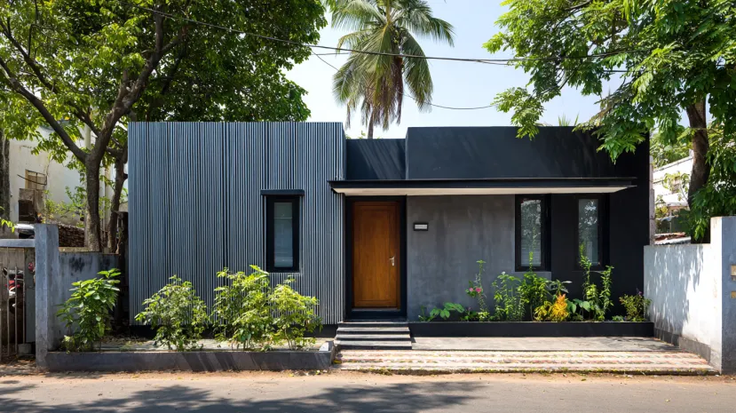 Small house elevation with grey metal panels and black walls