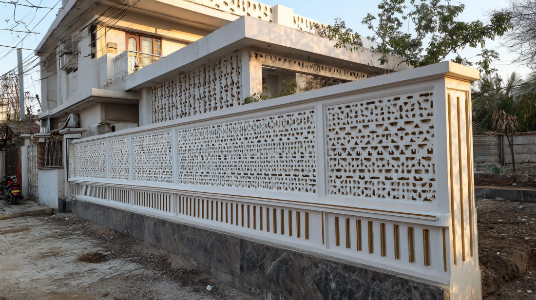 Decorative white PVC jali board on a compound wall