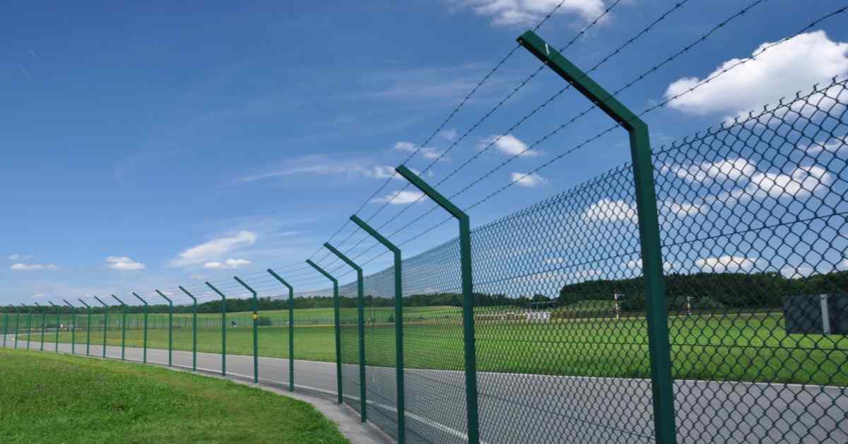 High-security boundary wall with sleek metal fence toppers