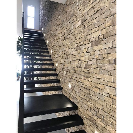Create drama on your staircase walls with asymmetrical stone cladding patterns